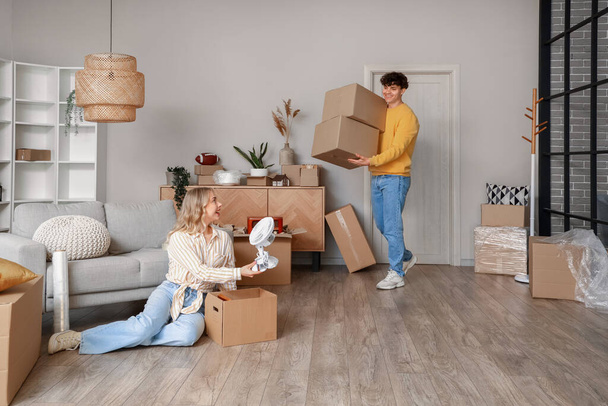 Young couple packing things in room on moving day - Φωτογραφία, εικόνα