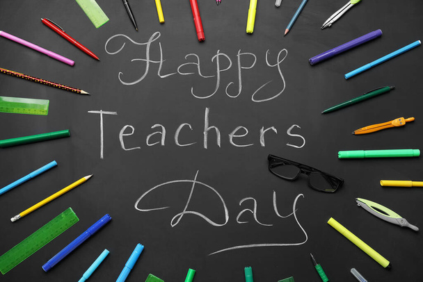 Frame made of different stationery with text HAPPY TEACHERS DAY on black chalkboard - Photo, image