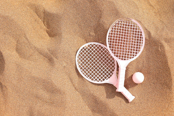 Beach tennis rackets and ball on sand, summer vacation activity - 写真・画像