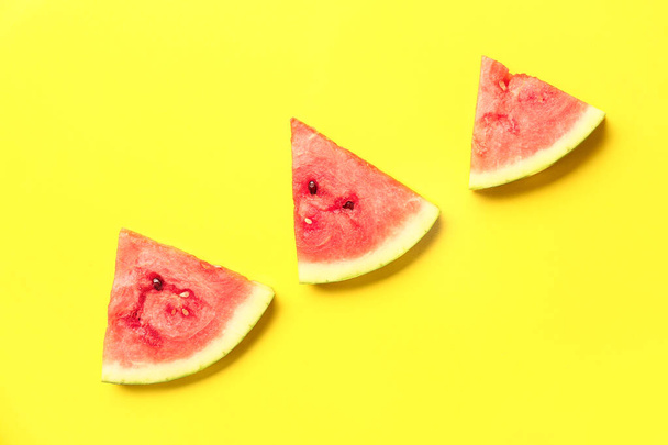 Pieces of fresh watermelon on yellow background - Fotó, kép