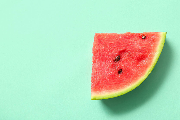 Piece of fresh watermelon on turquoise background - Foto, afbeelding
