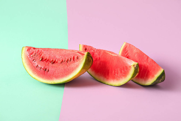 Pieces of fresh watermelon on colorful background - 写真・画像
