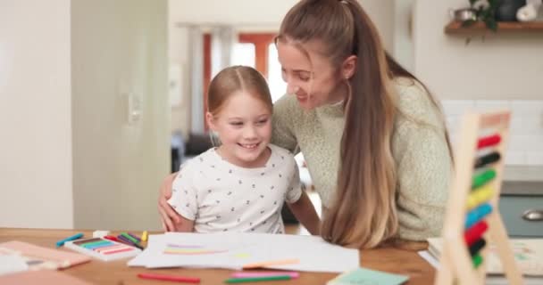 Learning, girl and mother with hug at house for education with childhood development in kitchen. Homework, help and mom or daughter with embrace or care or book with happy family working on table - Metraje, vídeo