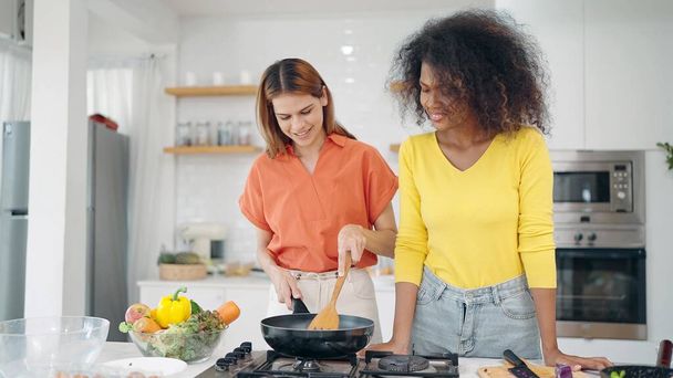Happy lesbian couple women enjoy cooking together in kitchen room at home. Two woman spending cooking time together in weekend at kitchen room. Lgbt relationship concept - Foto, immagini