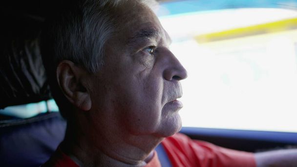 Προφίλ πρόσωπο γκρο πλαν ενός ανώτερου οδηγού στο δρόμο. Ηλικιωμένοι μετακινούνται στην πόλη, εσωτερικό πλάνο του οχήματος - Φωτογραφία, εικόνα