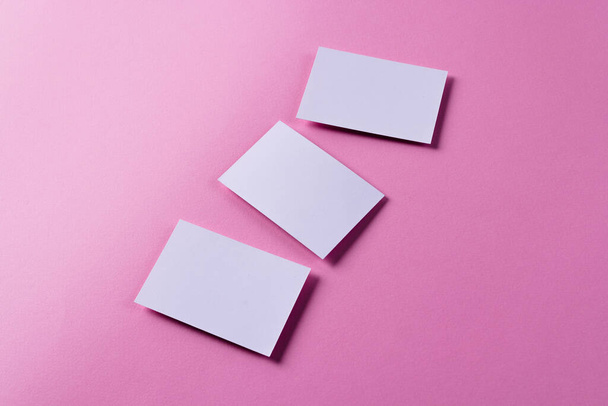 White business cards with copy space on pink background. Business, business card, stationery and writing space concept. - Fotoğraf, Görsel