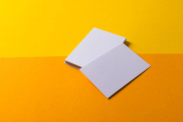 White business cards with copy space on yellow and orange background. Business, business card, stationery and writing space concept. - Fotografie, Obrázek