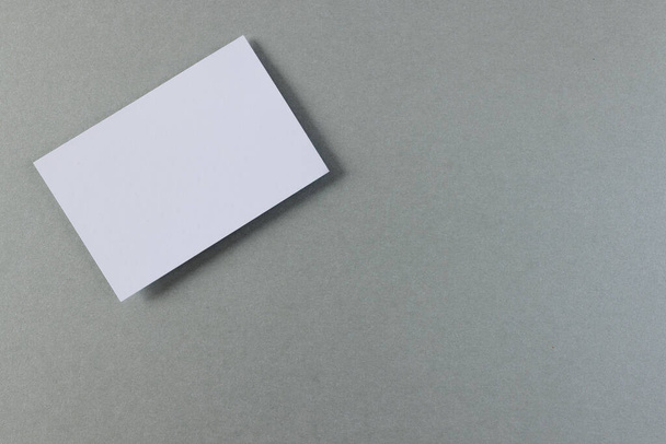 White business card with copy space on grey background. Business, business card, stationery and writing space concept. - Valokuva, kuva