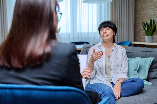 Mature woman at therapy meeting with psychologist, 50 year old female talking to therapist. Mental health of senior people, treatment, psychological help support, psychology psychotherapy concept - Photo, Image