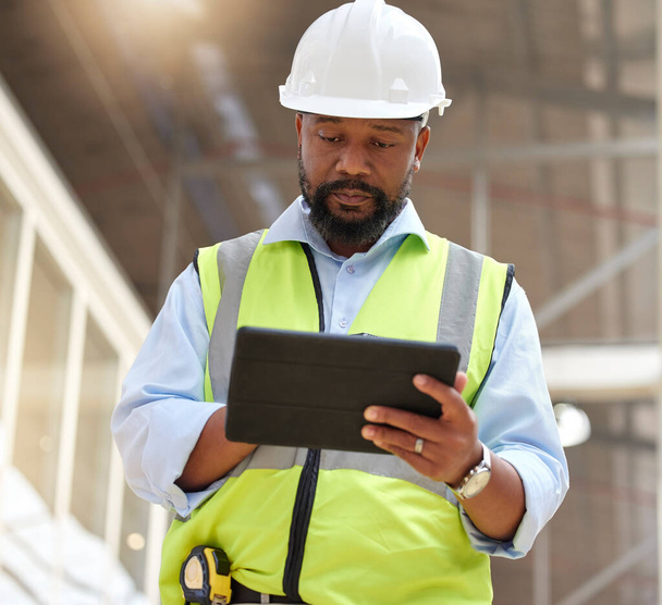 Tablet, engineering man and construction worker for online project management, building progress and floor plan. African person in architecture design on digital tech, renovation or industry software. - Photo, Image