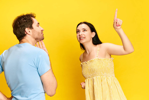 Dreams. Woman emotionally talking to man about vaccination against yellow studio background. Thoughtful husband. Concept of friendship, relationship, communication, emotions, lifestyle, ad - Fotó, kép