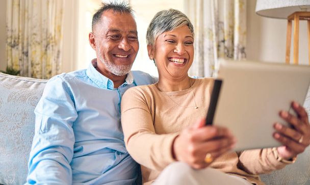 Senior couple, tablet and video call at home for communication, network connection or chat. Mature man and woman together with technology, social app and internet on a living room couch with a smile. - Photo, image