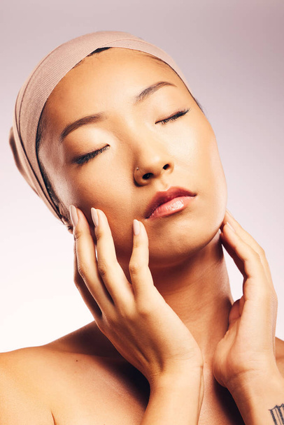 Skincare, dermatology and Asian woman with cosmetics, natural beauty and grooming against a white studio background. Female person, girl and model with treatment, glow and shine with luxury and spa. - 写真・画像