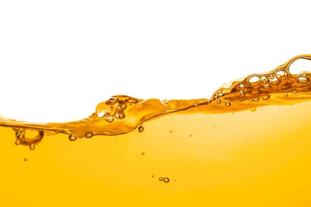 orange juice is isolated on white background. healthy fresh drink and natural waves. close up view. - 写真・画像