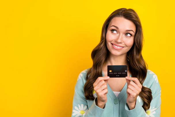 Photo of pretty positive lady hands hold plastic debit card look empty space isolated on yellow color background. - Valokuva, kuva
