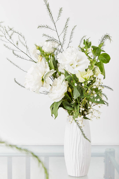Aesthetic white pastel bouquet of eustoma, rose, gypsophila. Biophilic interior, cozy home. - Photo, Image