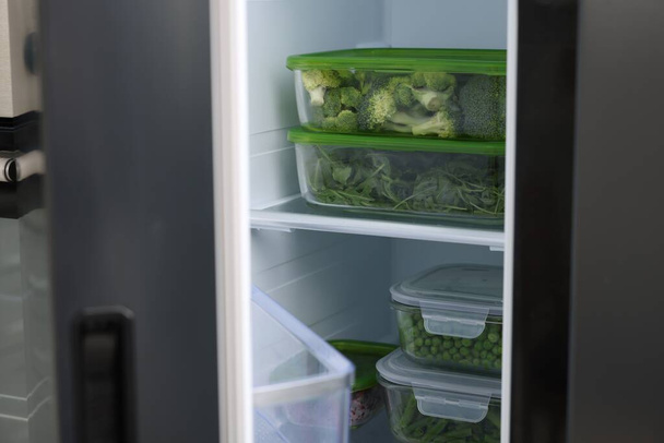 Glass containers with different fresh products in fridge. Food storage - Foto, immagini