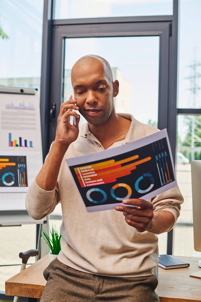 myasthenia gravis, bold african american businessman with eye syndrome having phone call while discussing charts, bold dark skinned office worker holding smartphone, inclusion  - Photo, Image