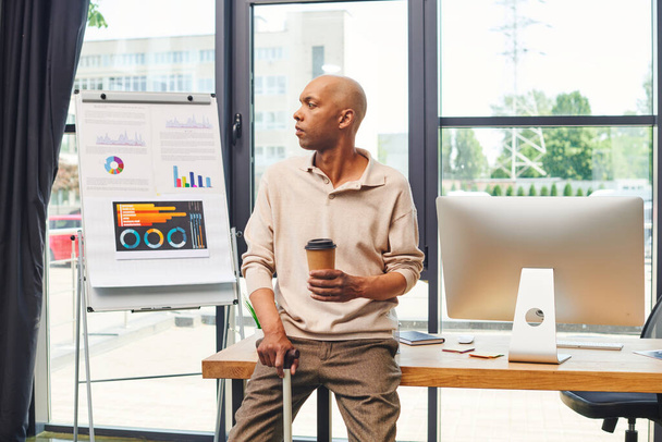 inclusion, myasthenia gravis syndrome, bold african american man standing with walking cane and to go coffee, computer monitor, dark skinned office worker in casual attire - Photo, Image