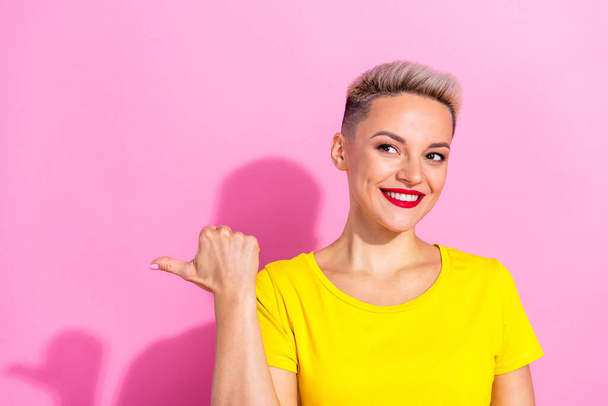 Photo of cute positive person look direct thumb finger empty space isolated on pink color background. - Fotografie, Obrázek