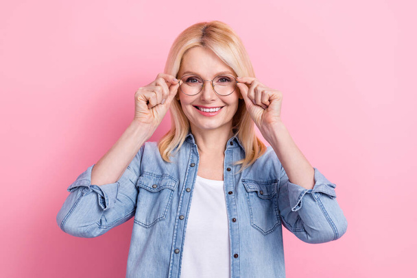 Photo of pensioner lady beaming smiling presenting computer glasses optician consultation prescription isolated pink color background. - Фото, зображення