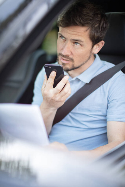 handsome man talking with phone while driving a car - Foto, Imagen