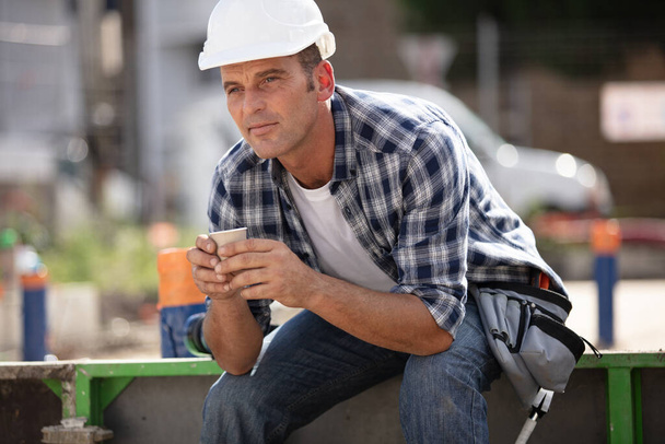 male construction worker having a break with coffee - Fotoğraf, Görsel
