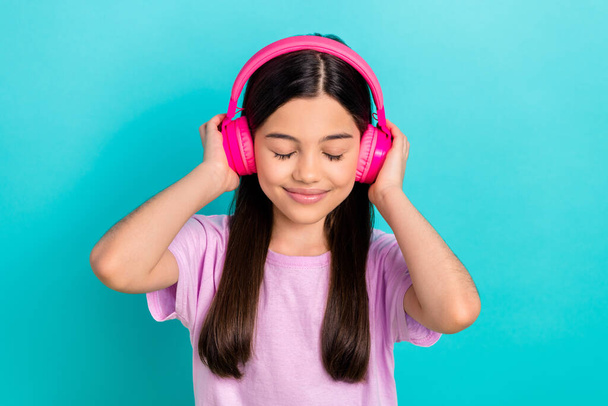 Photo of young funky girl brunette hair wear pink t-shirt listen music stereo sound high quality itunes isolated on blue color background. - Foto, Imagem