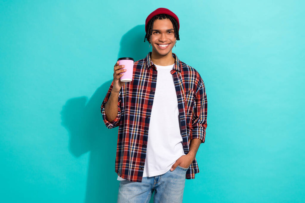 Photo portrait of attractive young male hold paper cup coffee house wear trendy plaid garment isolated on aquamarine color background. - Photo, image