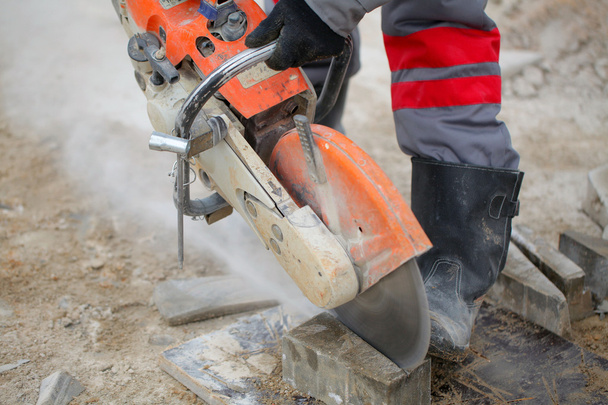 Construction worker using concrete saw - 写真・画像