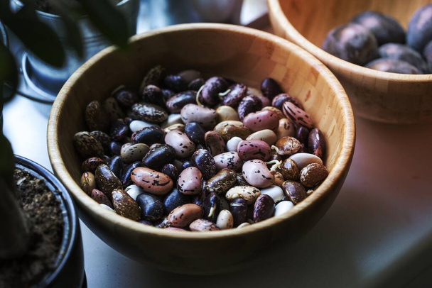 Assorted beans in a wooden bowl - Fotoğraf, Görsel