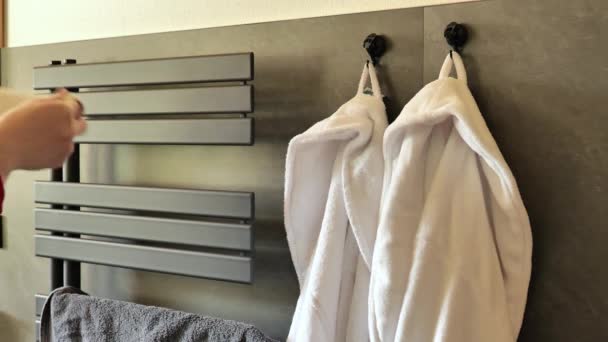 Drying towels. Change of towels.Towel and heated towel rail.Beige and gray terry fluffy towel on the heated towel rail in the bathroom.Order and cleanliness concept.Appliances and equipment - Footage, Video
