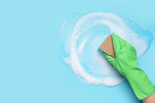Woman with sponge and foam cleaning on blue background - Photo, Image