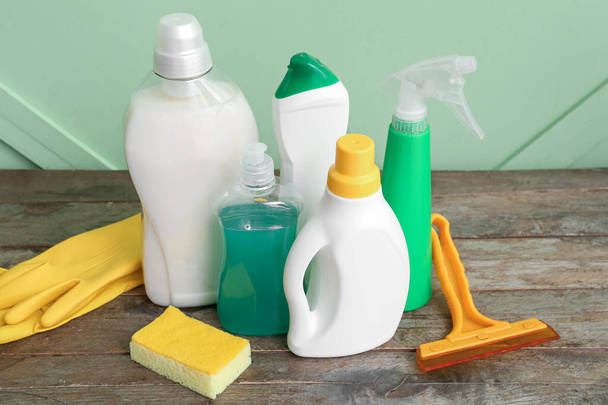 Different cleaning supplies on wooden table - Zdjęcie, obraz
