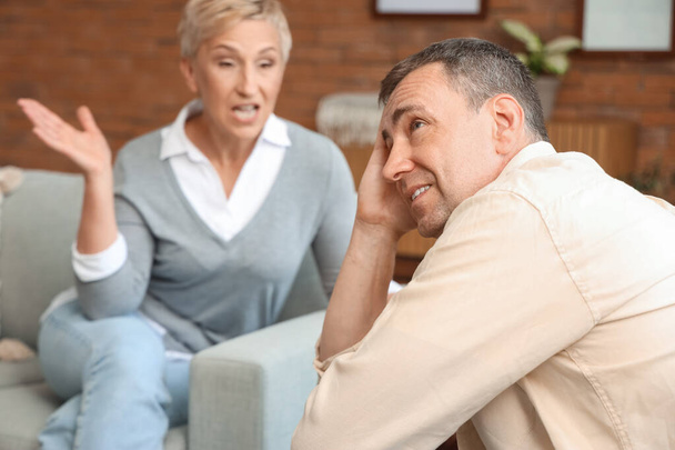 Mature man with his quarreling wife at home, closeup - Photo, image