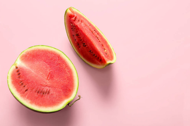 Half of fresh watermelon with piece on pink background - Photo, Image