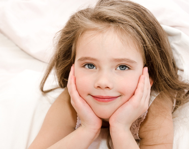 Adorable smiling little girl waked up - 写真・画像