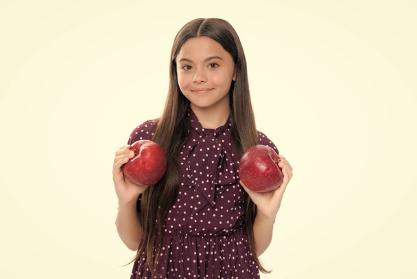 Teenager child with apple on yellow isolated background. apples are good for children. Portrait of happy smiling teenage child girl - Foto, Imagen