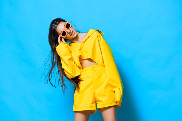 woman brunette isolated person caucasian long sunglasses attractive happiness girl joy hair young lifestyle fashion romance background trendy beautiful cheerful yellow portrait - Photo, Image