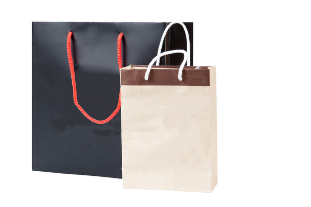kis barna táska és fekete bevásárló táska, elszigetelt fehér háttérben - Fotó, kép