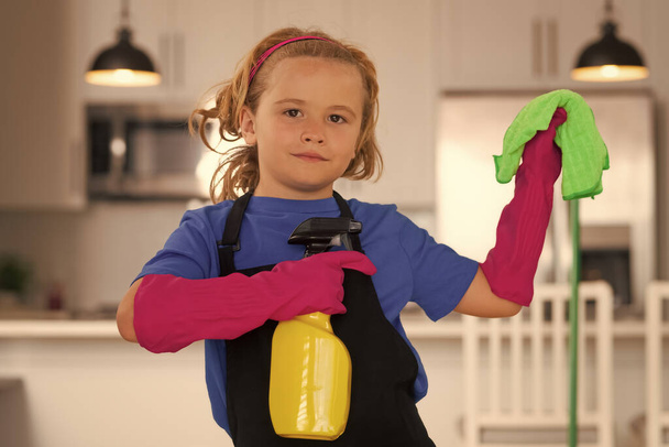 Cleaning house. Child use duster and gloves for cleaning. Funny child mopping house - 写真・画像