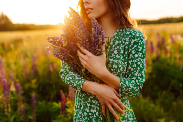 Young woman in lavender field on summer day. Nature, vacation, relax and lifestyle - Fotó, kép