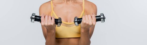 cropped, active lifestyle, woman exercising with dumbbells, white background, active wear, banner - Photo, Image