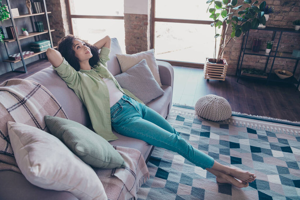 Full body length cadre of young lovely dreaming woman wearing casual clothes hands head take nap imagination relax chill weekend indoors. - Photo, image