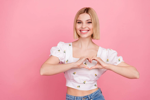 Portrait photo of young gorgeous sweet lady showing heart sign fingers wear trendy blouse summer season isolated on pink color background. - Фото, зображення