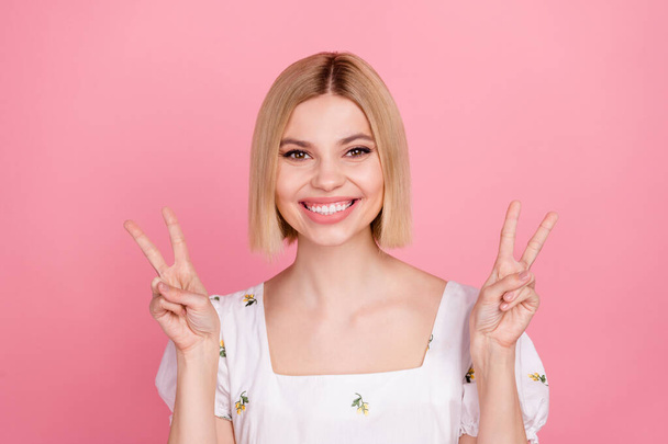 Portrait of cute cheerful young lady smiling toothy showing v sign wear vintage sleeved shirt isolated pastel pink color background. - Valokuva, kuva