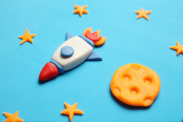 Creative craft plasticine rocket in open space, astronaut dreams. Stars, and moon. Cartoon art. - Foto, immagini