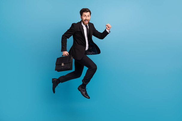 Full body photo of crazy run guy with diplomat suitcase businessman office manager hurry go his interview isolated on blue color background. - Foto, Imagen