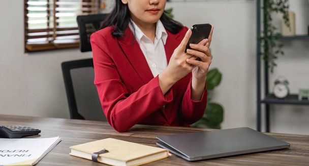 Young Asian business woman with a using smartphone at the office. - Photo, Image