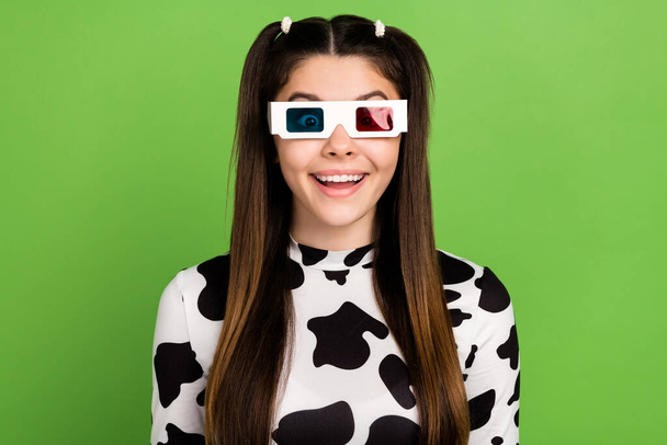 Photo of impressed cheerful girl toothy smile have good mood watch movie 3d glasses isolated on green color background. - Foto, Imagen